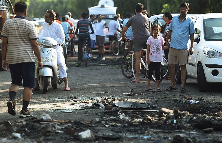 Scorch marks from items set on fire are seen on a road in Panchkula. — AFP