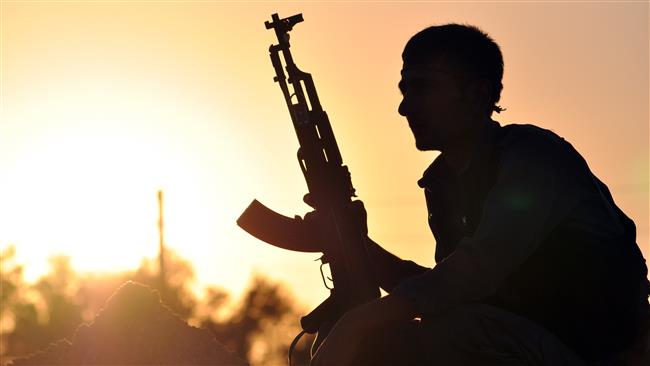 A fighter is seen at sunset in the Syrian town of Ain Issi, some 50 km (31 miles) north of Raqqa, on July 10, 2015.