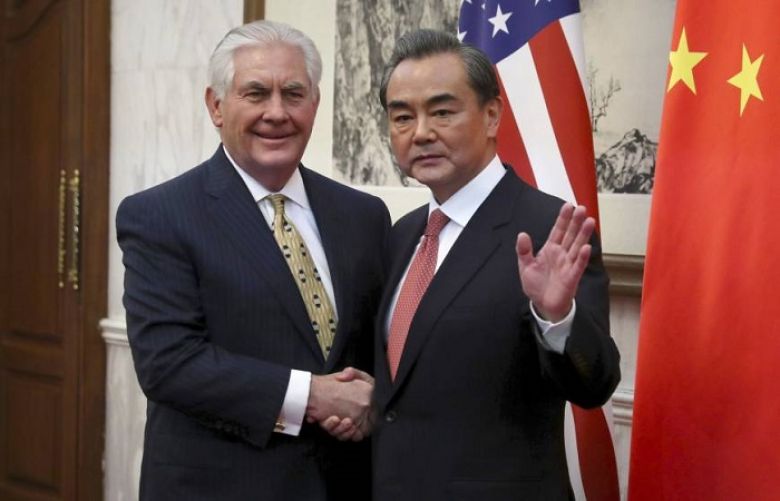 US Secretary of State Rex Tillerson (L) and China&#039;s Foreign Minister Wang Yi shake hands at the end of a joint press conference at the Diaoyutai State Guesthouse in Beijing.