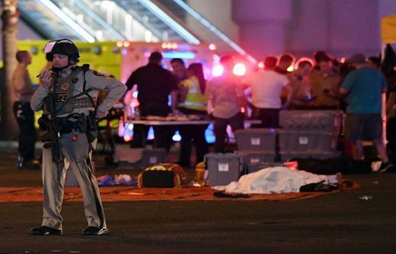 A Las Vegas Metropolitan Police officer stands in the intersection of Las Vegas Boulevard and Tropicana Ave after a mass shooting at a country music festival nearby on October 2, 2017 in Las Vegas, Nevada.
