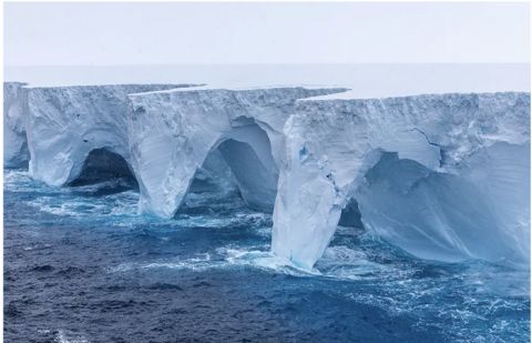 Erosion sculpts spectacular caves, arches in world's largest iceberg