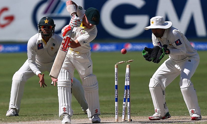 The bails fly as Australian batsman David Warner is bowled out by Yasir Shah.