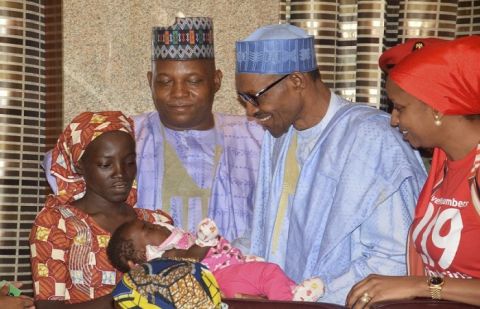 Nigeria President Muhammadu Buhari, second right, greets Amina Ali, left, the first rescued Chibok schoolgirl, at the Presidential palace in Abuja, Nigeria.