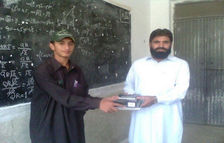 Shah Faisal receiving prize from his teacher.