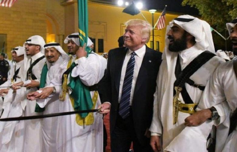 US President Donald Trump joins dancers with swords at a welcome ceremony ahead of a banquet at the Murabba Palace in Riyadh. 