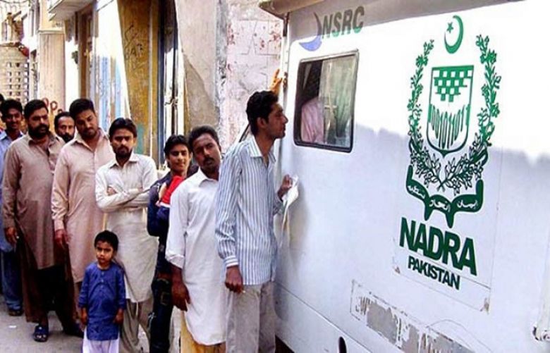 People stand in a que toapply for a Nadra CNIC.