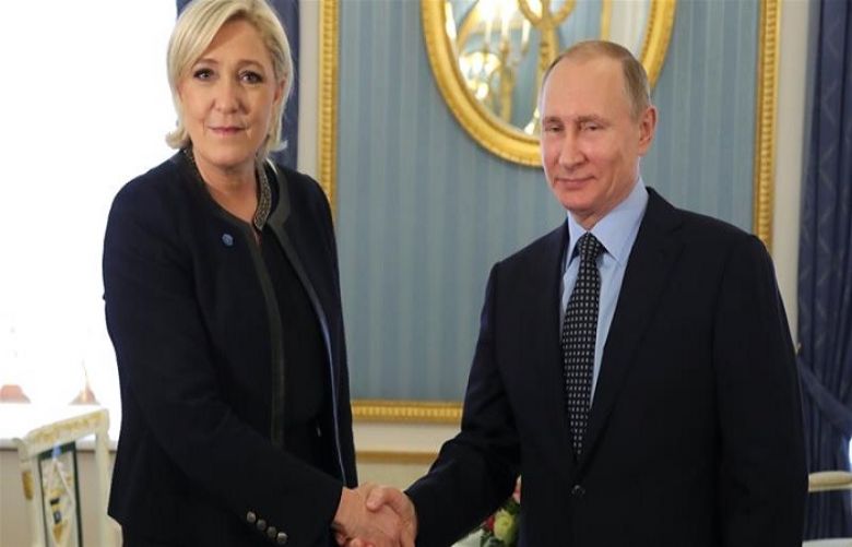 Russian President Vladimir Putin shakes hands with former French presidential election candidate Marine Le Pen during their meeting in Moscow on March 24, 2017