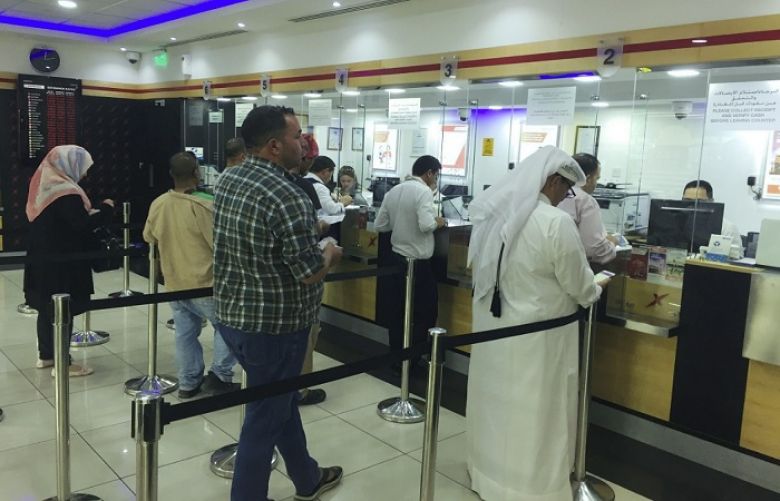 People exchange money at a money exchange office in Doha, Qatar, June 11, 2017.