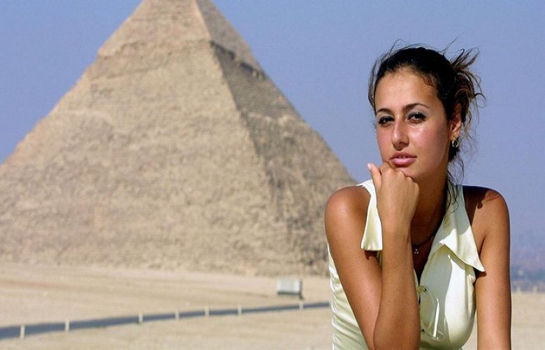 Hala Shiha poses in front of the Giza pyramids on 26 June 2001.