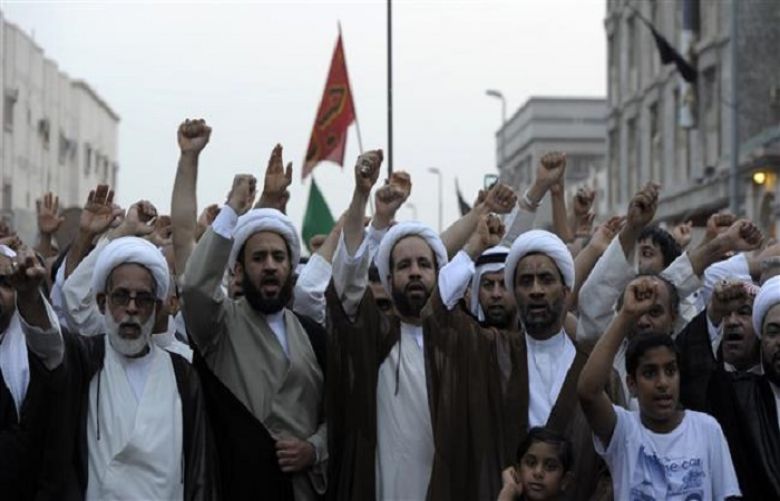 Saudi Shia clerics chant slogans as they march in Qudaih, in the mainly Shia Saudi town of Qatif, 400 kms east of Riyadh, on May 23, 2015, to condemn the attack on a Shia mosque which left 21 people dead and more than 200 wounded.