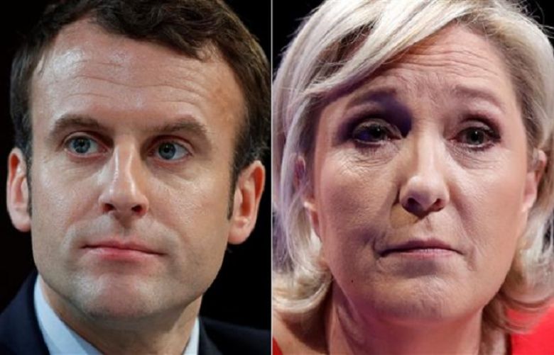 A combination picture shows portraits of Emmanuel Macron (L) and Marine Le Pen.