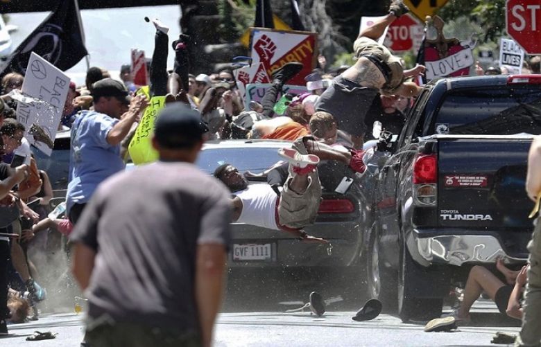People fly into the air as a vehicle drives into a group of protesters demonstrating against a white nationalist rally in Charlottesville, Va., Saturday, Aug. 12, 2017. The nationalists were holding the rally to protest plans by the city of Charlottesville to remove a statue of Confederate Gen. Robert E. Lee.