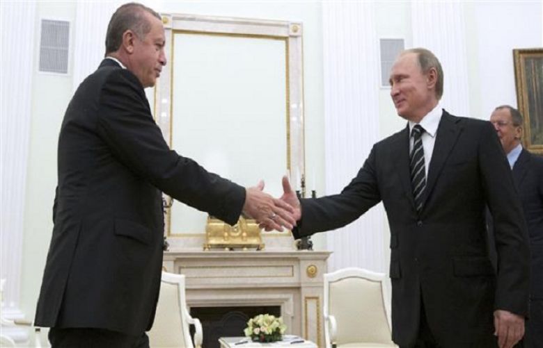 Putin shake hands with Turkish counterpart Tayyip Erdogan