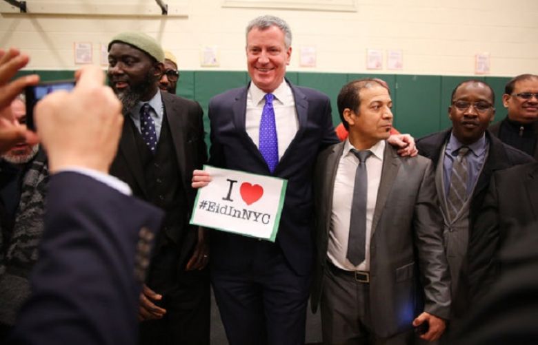 Mayor Bill de Blasio with Muslim leaders on Wednesday to announce the added school holidays.