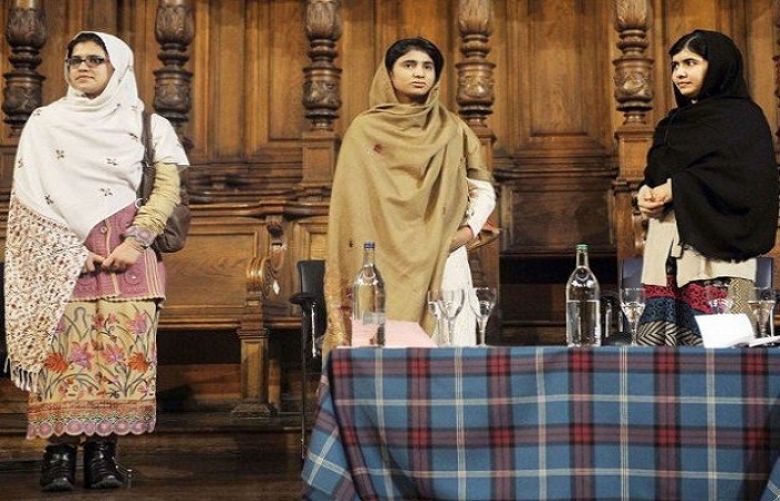 Three friends bonded by blood: Malala Yousafzai (R) stands next to her school friends Kainat Riaz (L) and Shazia Ramzan (C) during the first Global Citizenship Commission meeting at the University of Edinburgh in Scotland on October 19, 2013.