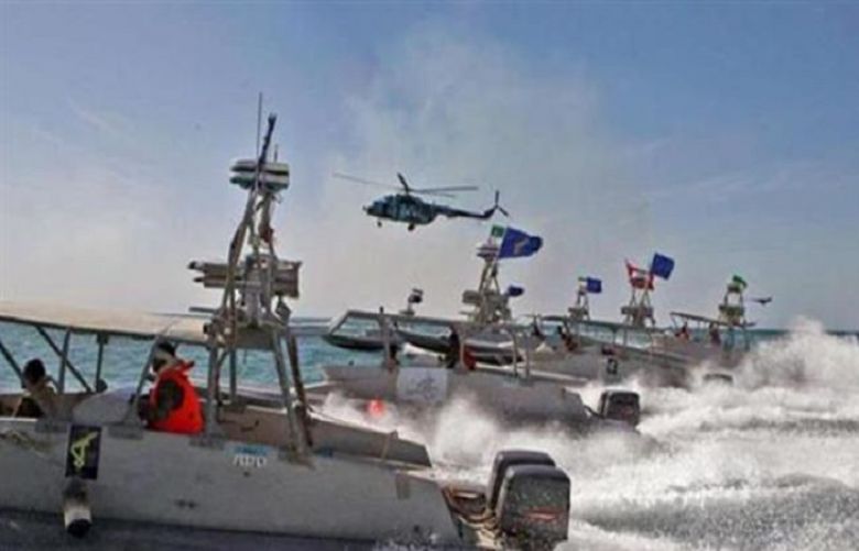 File photo shows Iran&#039;s Islamic Revolution Guards Corps&#039; speedboats cruising during military maneuvers in the Persian Gulf.