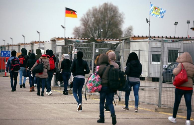 Eritrean migrants walk after arriving by plane from Italy at the first registration camp in Erding near Munich, Germany on Nov. 15. Government data showed that roughly 280,000 people entered Germany last year in search of asylum, down from a record of about 890,000 in 2015.