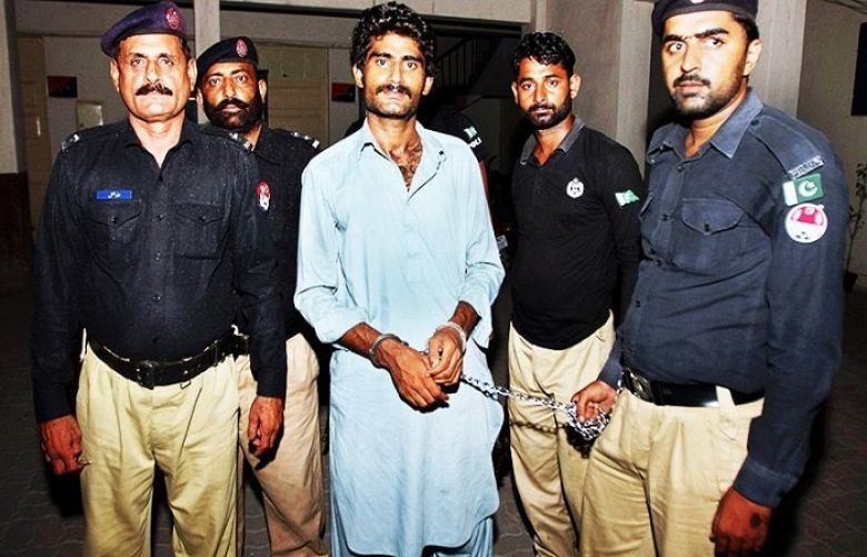 In this file photo, police officers present Waseem Azeem, the brother of slain social media star Qandeel Baloch.