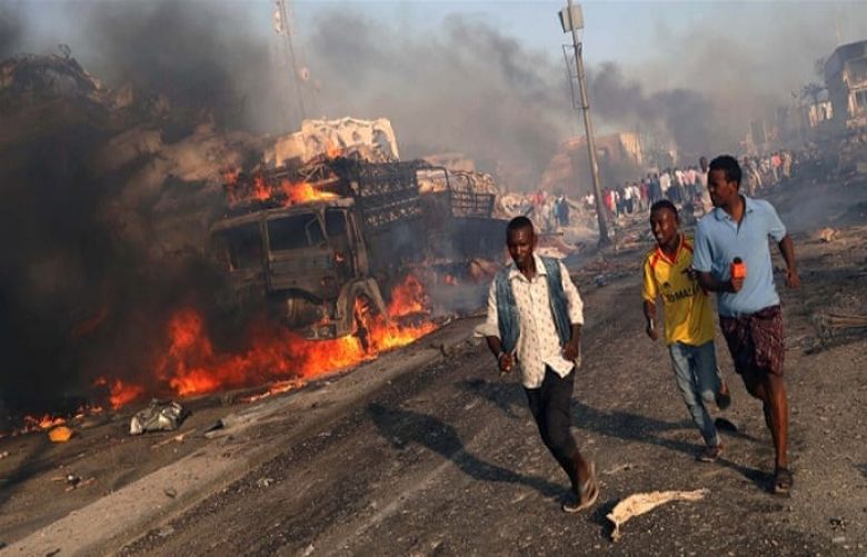 Civilians evacuate from the scene of the explosion in KM4 street in the Hodan district of Mogadishu