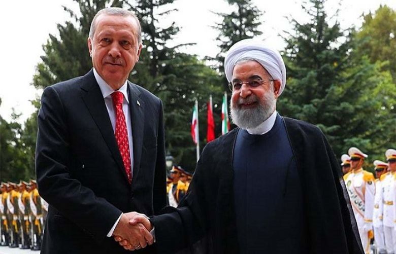 A handout picture provided by the Iranian Presidency shows Iran&#039;s President Hassan Rouhani (R) shaking hands with Turkish President Recep Tayyip Erdogan during a welcome ceremony in Tehran on October 4.