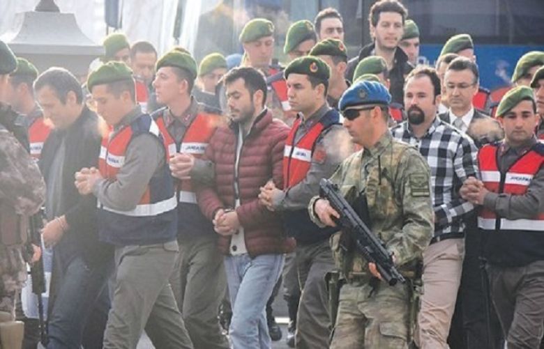 Paramilitary police escort suspects accused of plotting to kill Erdogan in February.
