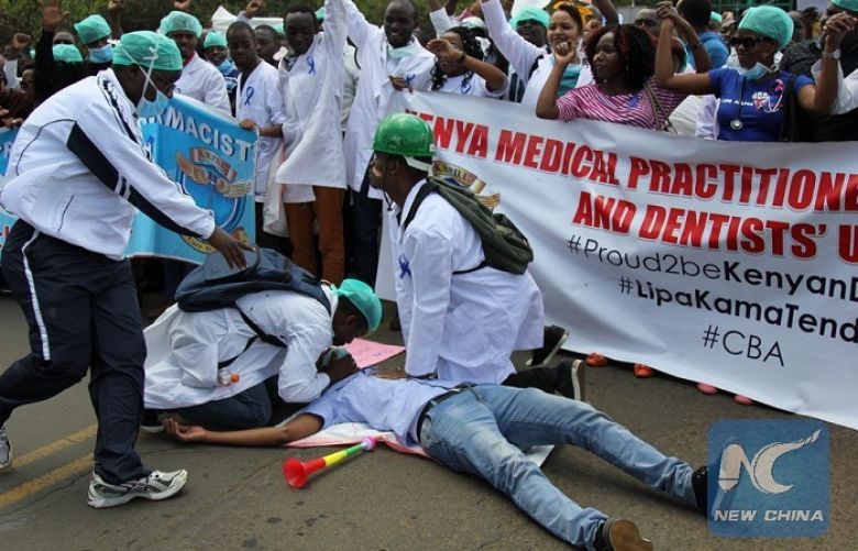 Kenyan striking doctors do a mock resuscitation during a demonstration in Nairobi