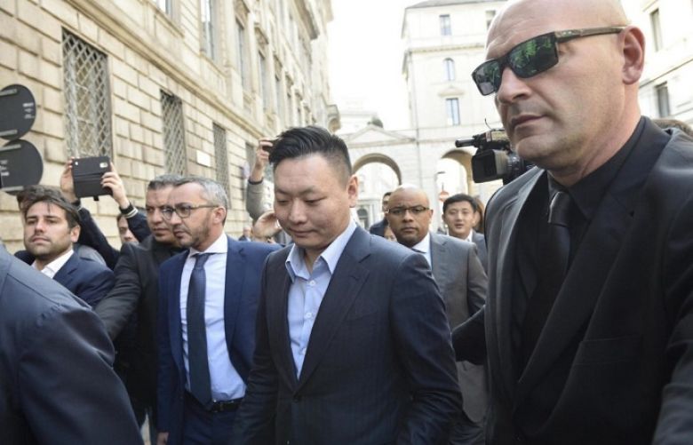 David Han Li, centre, arrives at a notary&#039;s office for the transfer of ownership