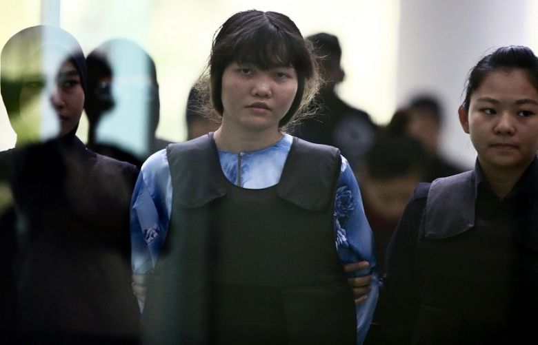 Doan Thi Huong is escorted by police officers as she arrives for a court hearing in Shah Alam, outside Kuala Lumpur, on Thursday.