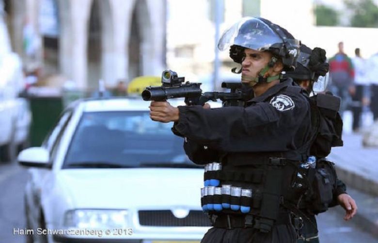 An Israeli Policeman prepares to fire a sponge-tipped bullet during a Nakba Day demonstration in East Jerusalem, May 15, 2013.