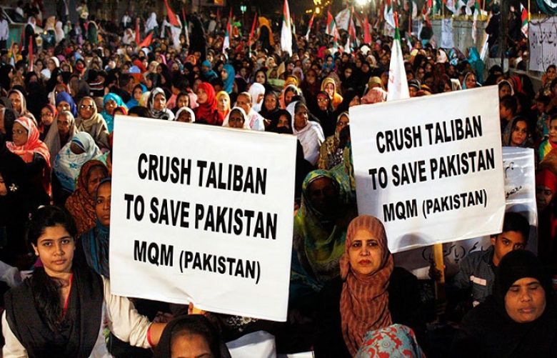 Activists of Muttahida Qaumi Movement (MQM) take part in a rally organised in solidarity with victims of Peshawar massacre in Karachi on Friday.