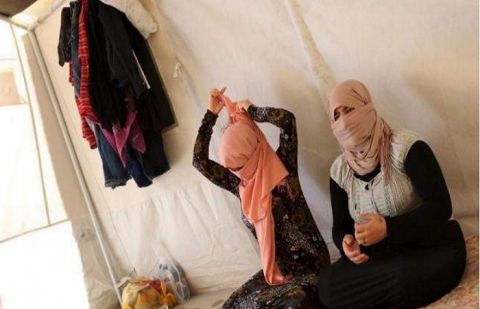 Yazidi sisters, who escaped from captivity by Daesh militants, sit in a tent at Sharya refugee camp on the outskirts of Duhok province July 3, 2015.