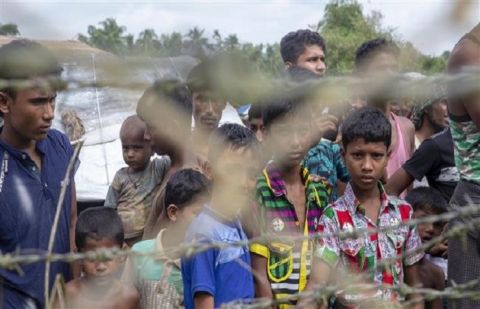 In this file photo taken on August 24, 2018, Rohingya refugees gather near the fence in the "no man's land" zone between Myanmar and Bangladesh border on August 24, 2018. 