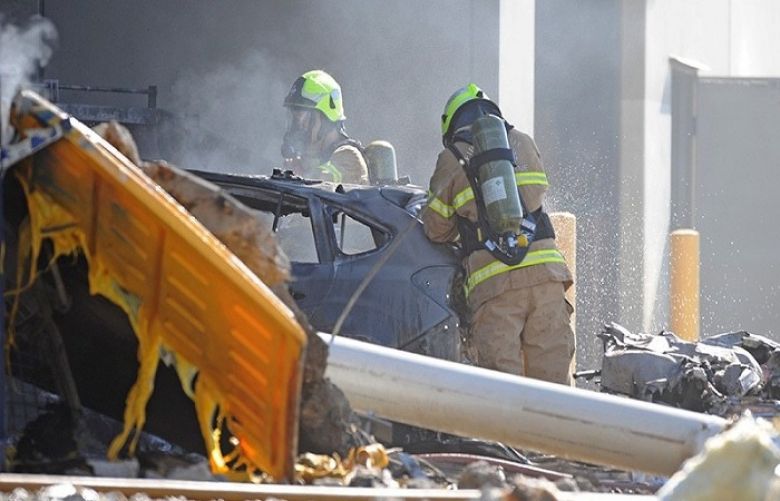Emergency services personnel are seen at the scene of a plane crash in Essendon in Melbourne.