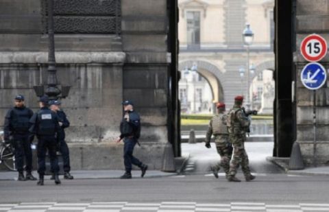 Police officers and soldiers patrol in front of the Louvre museum in Paris on February 3, 2017 after a soldier shot and gravely injured a man who tried to attack him, according to sources
