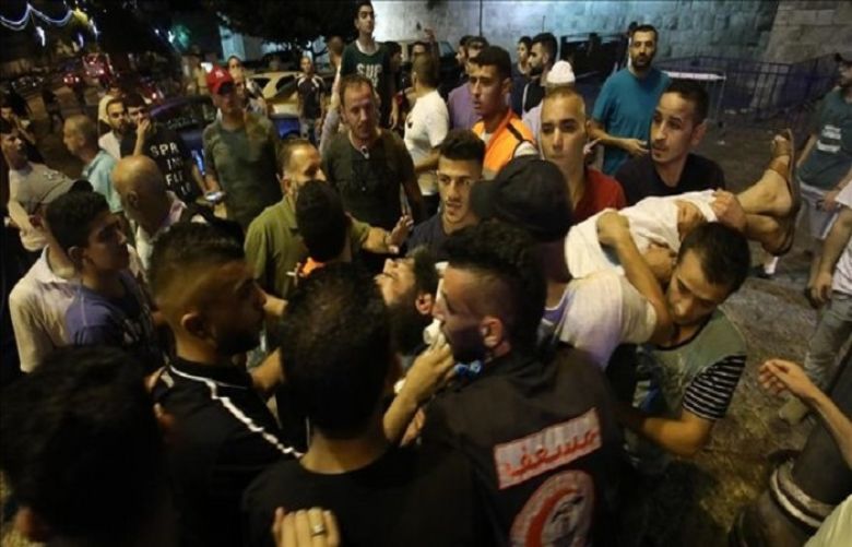 Israeli security forces clash with Palestinians outside the main entrance to the Al-Aqsa mosque