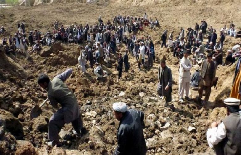 People search for survivors on May 9, 2014, following a landslide in Abi Barak village of Afghanistan’s northeastern province Badakhshan.