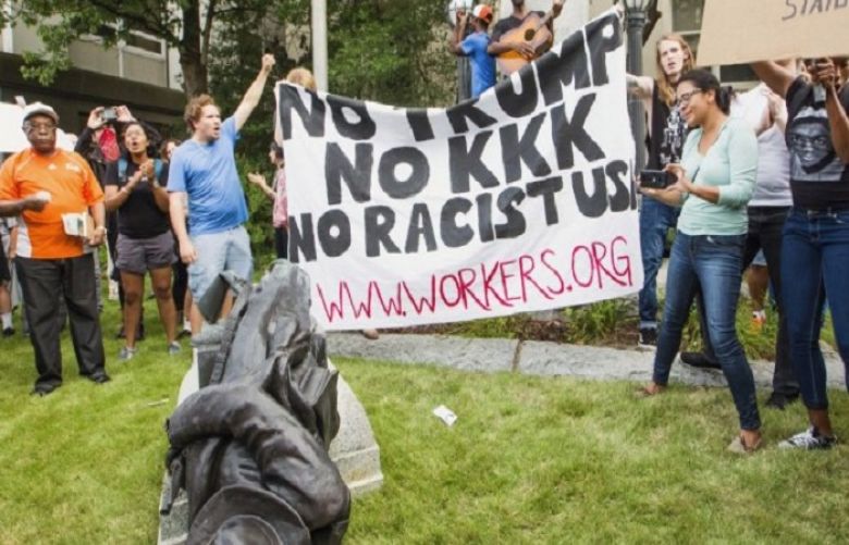 Protesters celebrate after toppling a statue of a Confederate solder in Durham, N.C