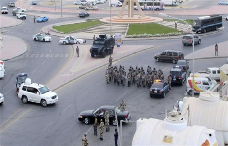 Saudi riot police gather as Saudi protesters (unseen) chant slogans during a demonstration in Qatif, Saudi Arabia, March 11, 2011.