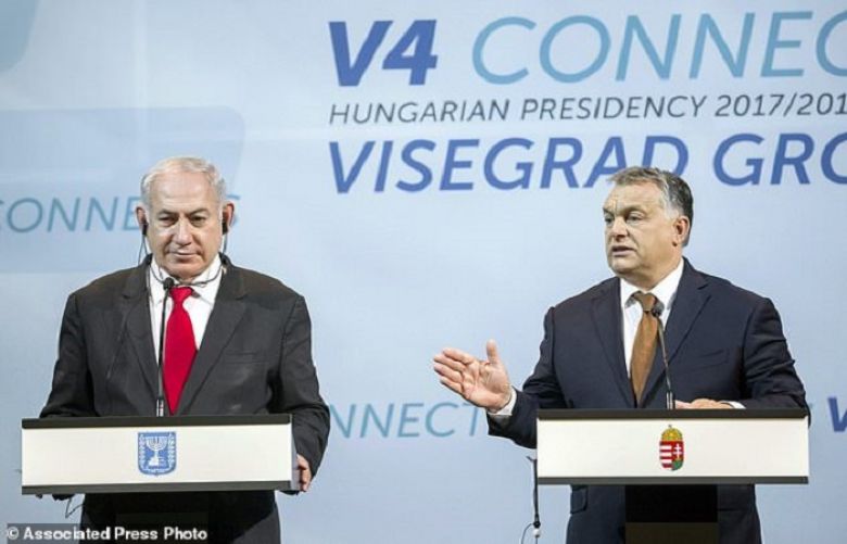 Israeli Prime Minister Benjamin Netanyahu, left, listens to Hungarian Prime Minister Viktor Orban during