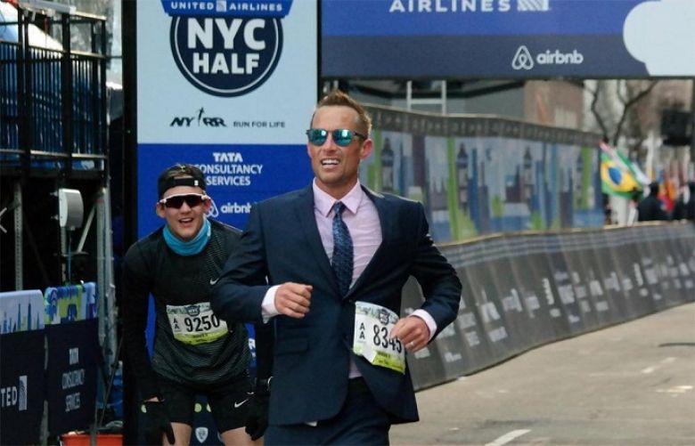Chris Estwanik placed 55th overall in the NYC Half, keeping both buttons on his suit jacket fastened the entire way.