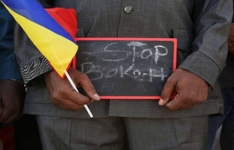 A man holds a sign that reads &quot;Stop Boko Haram&quot; at a rally