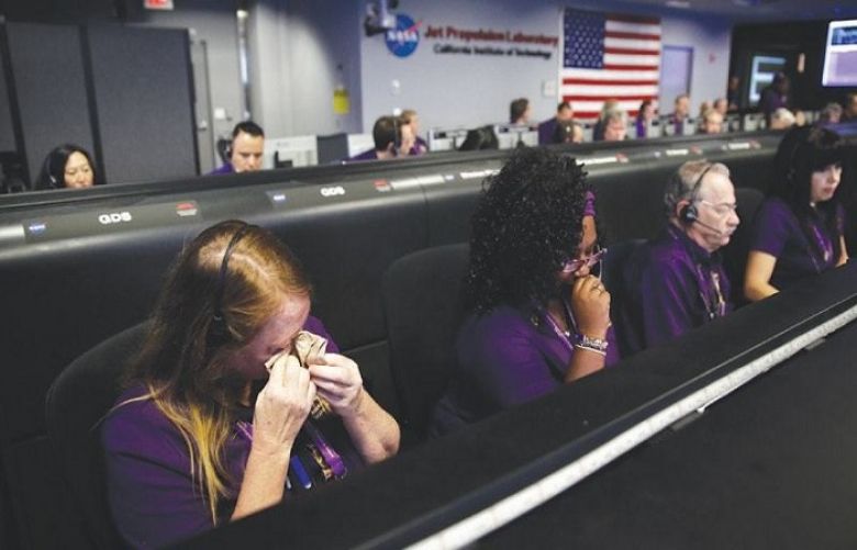 Engineer Nancy Vandermay (left) wipes her tears in mission control at Nasa’s Jet Propulsion Laboratory after confirmation of Cassinis demise on Friday.
