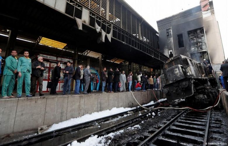 Security forces and onlookers gather at the scene of a fiery train crash at the Egyptian capital Cairo&#039;s main Ramses railway station on February 27, 2019