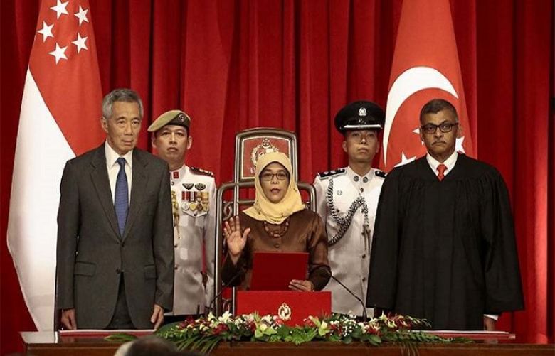 Singapore swears in first female president 