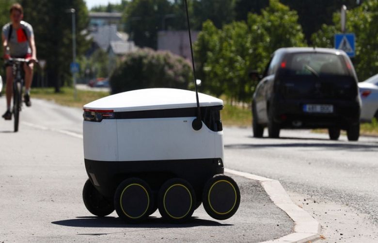 A delivery robot crosses a road in Estonia. 