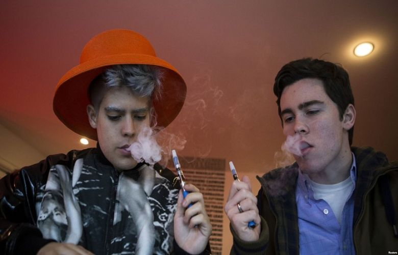 Customers puff on e-cigarettes at the Henley Vaporium in New York City, Dec. 18, 2013.