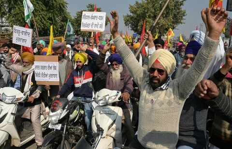 Indian police fire tear gas as protesting farmers march to capital