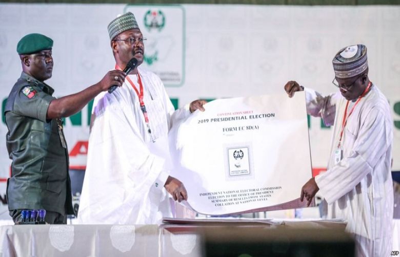Nigeria&#039;s Independent National Electoral Commission (INEC) chairman Mahmood Yakubu displays vote result sheets on Feb. 25, 2019 in Abuja