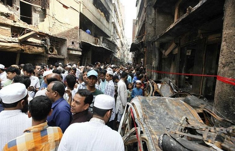 A crowd gathers at the site of Wednesday night&#039;s fire in Dhaka, Bangladesh.