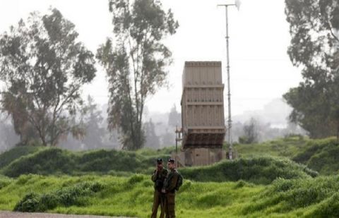 Israeli soldiers stand near an "Iron Dome" missile battery deployed in Tel Aviv on January 24, 2019. 